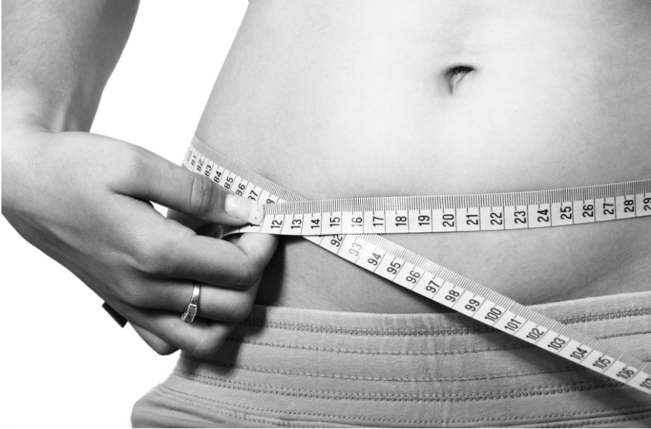 man measuring his waist
